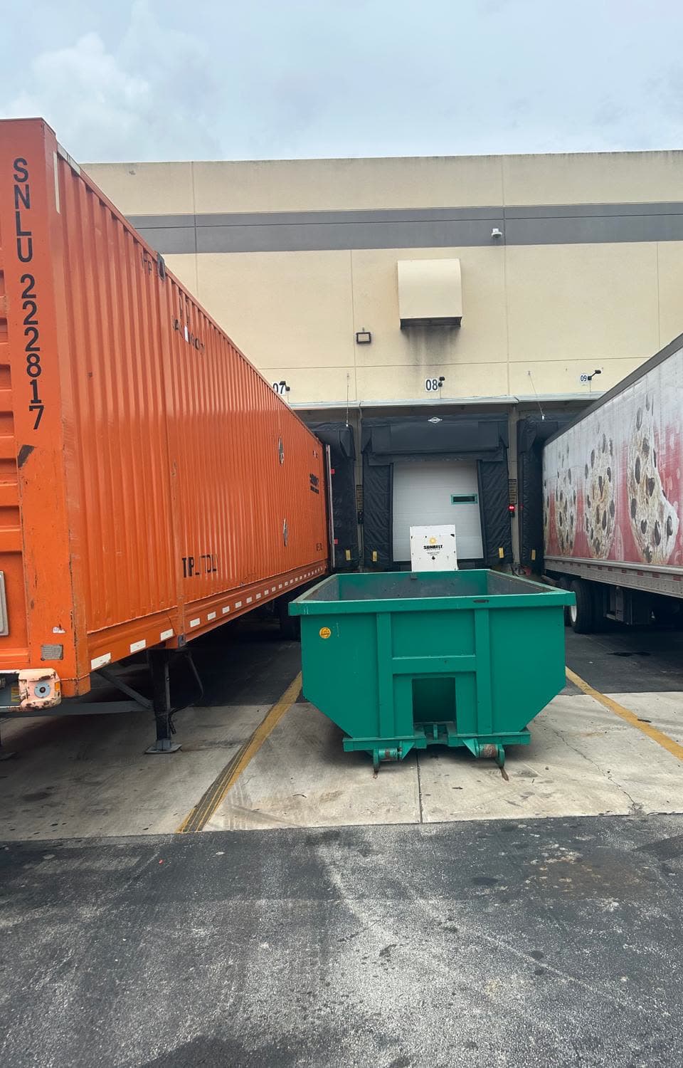 Roll-off dumpster placed at a warehouse loading dock